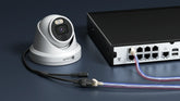 Power over Ethernet diagram showing PoE switch delivering data and power over a single Cat6 cable to a security camera